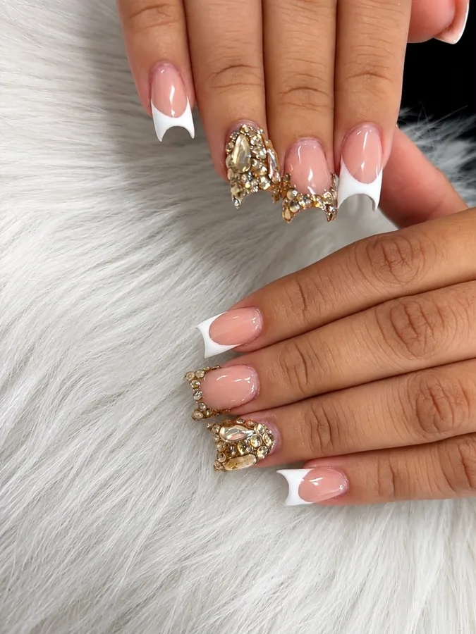 White French tips with gold rhinestone accents by Ashley