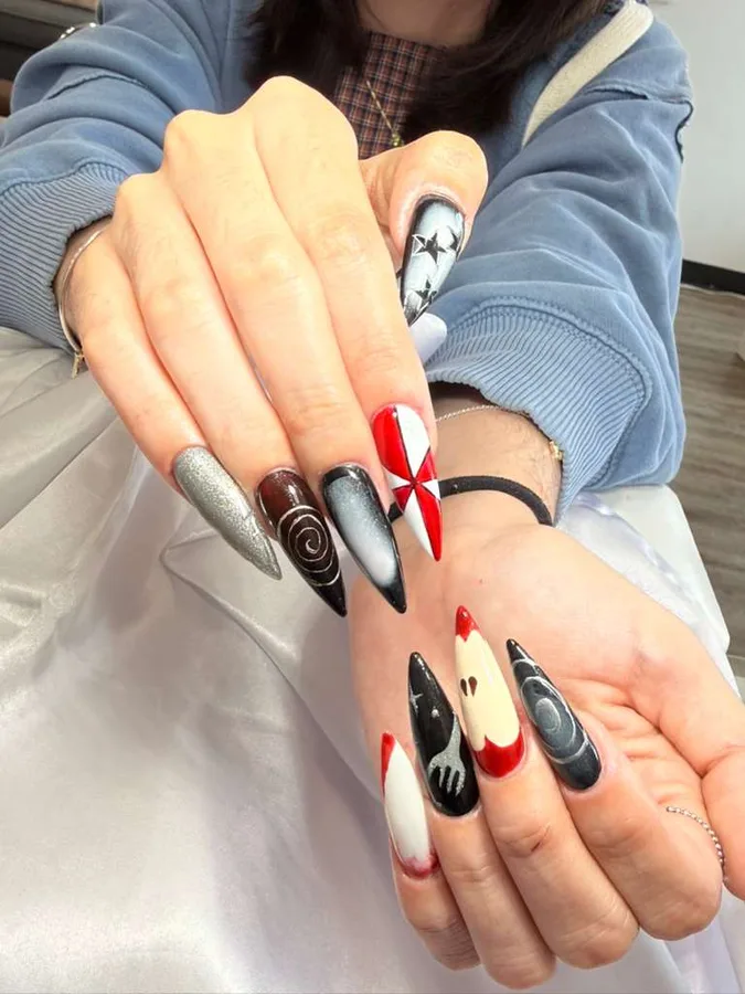 Long nails with black and red bow design by Jessica